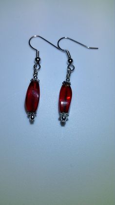 These pretty red glass bead earrings have silver accents and are hung from nickel free hooks. They make great Christmas presents for anyone on your listThese would make a beautiful addition to anyone's jewelry collection and make great gifts for friends and family! Holiday Red Beaded Earrings With Ear Wire, Red Sterling Silver Beaded Earrings, Nickel-free Red Beaded Sterling Silver Earrings, Red Sterling Silver Nickel-free Beaded Earrings, Red Beaded Sterling Silver Earrings, Nickel Free Red Crystal Earrings For Parties, Red Sterling Silver Beaded Earrings Gift, Red Sterling Silver Dangle Crystal Earrings, Red Sterling Silver Drop Crystal Earrings