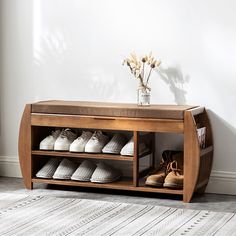 a wooden shoe rack with shoes on it