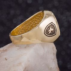 "This signet ring is crafted from 14K solid yelow gold and has a substantial feel to it with a designer quality finish. We can engrave your family crest on the top and sides of the ring and use our unique hand-crafted black finish to add contrast. We can also help you design a unique family crest using your choice of shield, symbols and text for an additional fee (please contact us for design pricing). ITEM DETAILS Item# SRGC006-FC Metal: 14K Solid Gold ITEM DIMENSIONS Width Widest Point: 18.23m Personalized Gold Rings, Oval Signet Ring, Bar Ring, Initial Ring, Custom Initials, Engraved Jewelry, Family Crest, Personalized Family, Jewelry Pouch