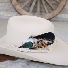 "This handmade arrangement of feathers is the perfect way to set your hat apart from the rest. Simply tuck into the band of any hat. Made with a mix of goose and rooster feathers, and an iridescent green pheasant feather at the front. Approximately 7 inches long, sizes may vary due to being made with natural materials.  Includes: 1 Handmade Arrangement of Feathers. How to use: Tuck into the hat band of any hat. *Hat not included. Hand made  Kaweah meaning \"crow cry\" or \"happy land\". Pronounc Brimmed Hat Bands With Feathers For Rodeo, Custom Feather Hat Bands For Country Events, Custom Hats With Feathers For Rodeo, Feathered Short Brim Hat Bands For Western-themed Events, Feathered Brimmed Felt Hat For Ranch, Brimmed Felt Hat With Feathers For Ranch, Feathered Hat Bands For Western-themed Events, Ranch Brimmed Felt Hat With Feathers, Western Hat Bands With Feathers For Rodeo