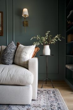 a living room with a white couch and blue walls