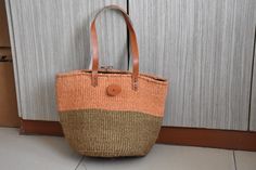 Sisal Woven Basket Bag, African Woven Market Handbag Summer Bag, Kenyan Kiondo Sisal Basket, African Purse With Leather Handles  Handwoven Sisal Basket made by the local women of the Kamba community Kenya.  The Multipurpose basket is eco friendly, durable and fashionable.  DIMENSIONS Bottom width: 12inches/ 30.48cm  Height: 12 inches/ 30.48cm  Handles: 6 inches SHIPPING All our orders ship via DHL Express (3-5 days) delivery time.  To shop more baskets: Zarabaskets.etsy.com Orange Straw Travel Bag With Leather Handles, Daily Use Orange Straw Bag With Leather Handles, Orange Straw Shoulder Bag For Shopping, Brown Pouch Straw Bag With Top Carry Handle, Orange Shoulder Bag With Removable Pouch For Vacation, Orange Bucket Crochet Bag For Everyday Use, Orange Straw Bag With Adjustable Strap For Everyday, Orange Bucket Straw Bag For Daily Use, Orange Crochet Bucket Bag For Everyday Use