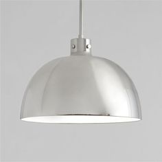 a large metal light hanging from a ceiling