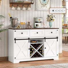 a white buffet table with wine bottles on it