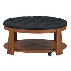 a round wooden table with a black cushion on it's top and casteors