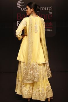 Yellow short kurta with placement floral embroidery. Comes with sharara and dupatta.
Components:3
Embroidered
Neckline:Round
Sleeve Length:Full
Fabric:Georgette
Color:Yellow  
Split neckline
Front buttons
Metallic trim
Embroidered sharara and dupatta - Aza Fashions Designer Sharara With Intricate Embroidery And Straight Kurta, Designer Raw Silk Sharara With Intricate Embroidery, Designer Sharara With Intricate Embroidery In Raw Silk, Sharara With Intricate Embroidery For Reception, Eid Silk Sharara With Intricate Embroidery, Eid Sharara With Intricate Embroidery In Dola Silk, Anarkali Designer Sharara With Intricate Embroidery, Designer Chanderi Sharara With Intricate Embroidery, Designer Dola Silk Sharara With Resham Embroidery