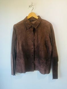 Vintage Express Chocolate Brown Suede Jacket in excellent vintage condition. Button down fits size S best. Raw unfinished suede in the most beautiful chocolate color. Nice matching stitching throughout back and arm panels. Unfinished edges. Dry clean. Approx. Measurements: Length: 27" Underarm to underarm: 20" Fitted Brown Leather Jacket With Collar, Fitted Brown Leather Collared Jacket, Brown Suede Leather Jacket With Buttons, Brown Collared Leather Jacket With Buttons, Fitted Brown Leather Button-up Jacket, Brown Leather Jacket With Snap Buttons, Brown Suede Outerwear With Buttons, Brown Suede Leather Jacket, Beautiful Chocolate