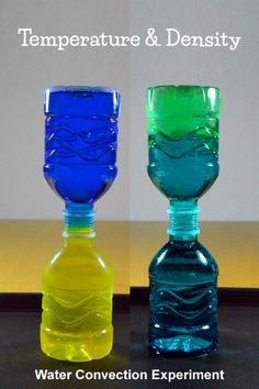 two different colored glass vases sitting next to each other