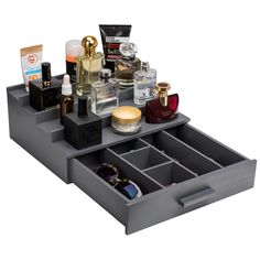 an assortment of cosmetics and beauty products are arranged in a drawer on a white background