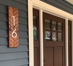 the front door of a house with a sign on it