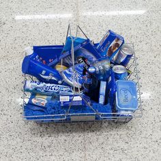 a basket filled with blue items on top of a floor