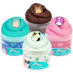 three different colored cupcakes in plastic containers on a white background with an owl, monkey and giraffe sticker