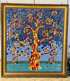 a mosaic art piece with a tree on it