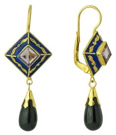 These earrings suggest the beauty and mystery of the Far East of the Mongolian hoards. A pale hand faceted amethyst is held in a diamond of deep blue enamel, from which swings a black onyx pendant. 24k gold over sterling silver setting. European backs for pierced ears. Size: 1 7/8 Inch. Kublai Khan, Egypt Jewelry, Roman Jewelry, Replica Jewelry, Blue Accessories, Laurel Burch, Knot Earrings, Garnet Earrings, Vintage Jewels