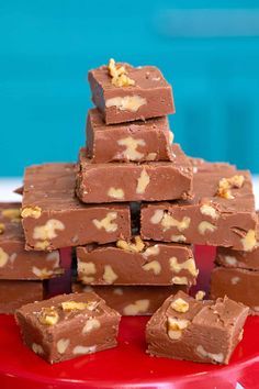 a stack of chocolate fudges on a red plate