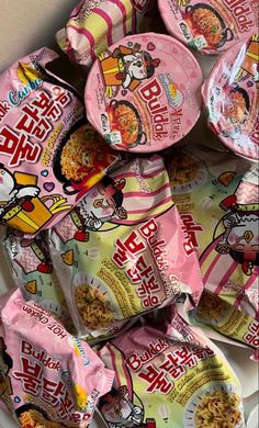 a pile of hello kitty cereal bags sitting on top of a table next to other snacks