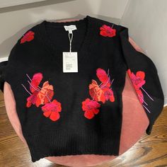 Black Sweater With Red Flower Size S 55% Wool 45% Polyamd New Never Worn Tag On Winter Black Sweater With Floral Print, Black Floral Print Sweater For Winter, Black Long Sleeve Sweater With Floral Print, Los Angeles Apparel, Black Sweater, Red Flower, Cozy Sweaters, Red Flowers, Colorful Sweaters