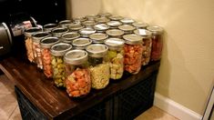 a table topped with lots of jars filled with food