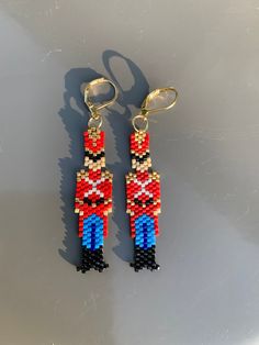 a pair of earrings made out of beads