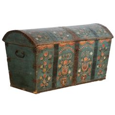 an old wooden chest with painted designs on it's sides and bottom paneling