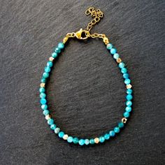 Beautiful Teal Blue Natural Apatite Beaded Bracelet. Genuine Gemstone Beads 2mm With Gold Plated Beads Spaced Throughout. Chain Is 18k Pvd On Stainless Steel Bracelet Measures 6.5" With 1" Extender Looks Pretty Stacked With A Gold Chain. See My Gold Chains In My Shop To Bundle And Save! Tags - Gift For Aunt Sister Gift For Girlfriend Wife Gift For Mother Gift Grandmother Bridesmaid Gift Stocking Stuffer Birthstone Vacation Jewelry Resort Wear Versatile Necklace Turquoise Whimsical Jewelry Elegan Dainty Blue Beaded Bracelets With Faceted Beads, Blue Crystal Bracelet With Tiny Beads, Blue Gemstone Beads Rondelle Beaded Bracelets, Blue Rondelle Gemstone Beaded Bracelets, Apatite Beaded Bracelets As Gift, Adjustable Apatite Beaded Bracelets, Vacation Jewelry, Gift For Aunt, Chevron Bracelet