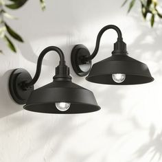 two black outdoor lights on a white wall