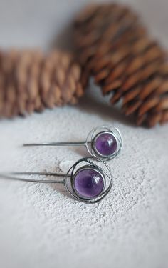 This oxidized sterling  silver purple earrings are handmade and unique. Because of this, there may be small difference in each piece. I used sterling silver (925) and amethyst gemstone  with silver smithing technique.  Since amethyst is a natural stone, there may be slightly difference in shades of purple. This lovely earrings are very suitable for daily use. Amethyst is the birthstone of february and Aquarius. You can choose it's a gift alternative for geometric jewelry and purple  lovers. Dime Purple Metal Earrings As Gift, Purple Metal Earrings For Gift, Handmade Purple Metal Earrings, Oxidized Finish Dangle Earrings As A Gift, Oxidized Finish Dangle Earrings For Gift, Handmade Purple Sterling Silver Earrings, Purple Round Metal Earrings, Minimalist Purple Earrings With Ear Wire, Round Earrings With Oxidized Finish As Gift