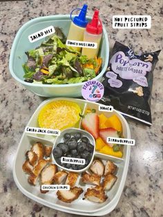 two plastic containers filled with food on top of a counter