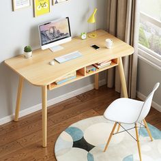 a wooden desk with a computer on top of it next to a chair and window