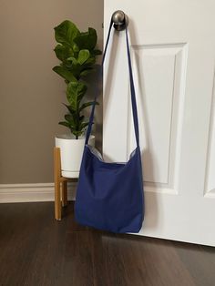 "This handmade medium size slouchy shoulder bag is 100% navy blue cotton and comes fully lined in a blue & white striped cotton. This bag is reversible. It has a pocket on the inside for your cellphone etc.   Velcro closure. Measurements: Width 15\" x height 15\".  Total length from bottom to top of strap is 42\" Wash cold/low heat and hang to dry. Iron if needed." Christmas Gifts For Grandma, Hobo Bags, Feb 2, Metal Straws, Grandma Gifts, Perfect Christmas Gifts, Hobo Bag, Crossbody Shoulder Bag, Medium Size