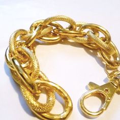 ♥This unique bracelet is a classic high polish gold colour chain connected with chunky textured links and a large clasp. It has a nice weight and it is very comfortable on the wrist.♥This lovely bold and chunky bracelet looks trendy on its own or can be stacked and mixed with other bracelets.♥Has a matching necklace.♥Please let me know if you would like an additional length in notes to seller section when checking out.♥It measures 7.5 inches.---------------------------------------Order tracking- Bold Gold Bracelets For Gifts, Bold Gold Bracelets For Gift, Chunky Chain Link Metal Bracelets, Chic Chunky Chain Gold Bracelet, Trendy Chunky Link Chain Bracelet, Chic Gold Bracelet With Chunky Chain Links, Chic Gold Chain Bracelet With Lobster Clasp, Gold Chain Bracelet With Lobster Clasp, Gold-tone Chunky Chain Bracelet With Oval Links