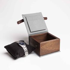 "A simple wooden watch box. The perfect gift for a watch lover. It is ideal for storing a watch that is not used every day. The box will also add a unique character to the watch that someone is about to give. Thanks to this box, the watch will be securely hidden. The box is made of solid mahogany. The bottom and lid of the box are covered with cotton fabric. Inside there is a satin black watch cushion. The box is closed with a natural leather strap. On the inside of the lid, there is room for a Personalised Wooden Box, Wooden Watch Box, Watch Lover, Wooden Watch, Solid Mahogany, Wood Surface, Watch Box, Black Watch, Wooden Box