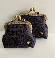 two blue purses with gold stars on them