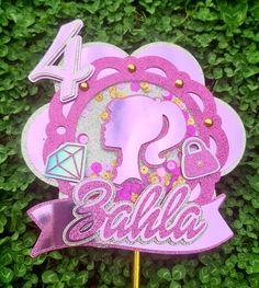 a pink cake topper with the number four on it