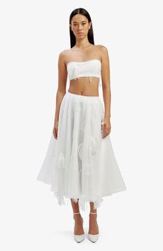 Here's an organza midi skirt that proves that everything is more fun when you add fringe. 30 1/2" length Hidden side-zip closure Lined 100% polyester Hand wash, line dry Imported Chic Organza Party Bottoms, Elegant Feather Trim Bottoms For Summer, Spring Long Skirt With Tassels, White Fitted Fringe Skirt, Elegant Summer Skirt With Tassels, Long Skirt With Tassels For Spring, Spring White Skirt With Tassels, White Tassel Skirt For Spring, Summer Party Organza Skirt