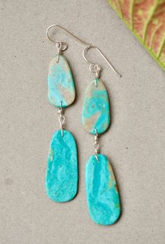 Native American double slab earring by artist Ronald Chavez Beautiful turquoise earrings with double slab. Gorgeous blue tones and soft matrix. Great pair of earrings by the talented Santo Domingo artist Ronald Chavez. Measurements : top slab : 1" X 0.5" bottom slab : 1 3/8" X 5/8" total length : 2 13/16" sterling silver turquoise Artsy Turquoise Nickel-free Earrings, Artsy Turquoise Nickel-free Jewelry, Artsy Nickel-free Turquoise Earrings, Artistic Turquoise Jewelry With Matching Earrings, Native American Jewelry, Blue Tones, Turquoise Earrings, Silver Turquoise, Turquoise Sterling Silver