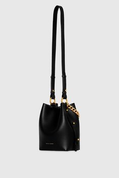 Not your average bucket bag, the Kate Small Bucket is crafted from genuine leather and gives you all the strap options. Carry it effortlessly by the chain top handle, by its long strap over your shoulder, or as a crossbody. Style# CF24TKAUSM 100% Genuine Leather Antique Brass Hardware 10. 5"W X 8. 5"H X 4. 5"D Detachable Strap - Strap Drop 19. 5" Chain strap Snap Closure Imported The photos featuring a model are for size reference only. Actual color and material may vary from what is depicted. | Modern Bucket Bag With Gold-tone Hardware For Everyday Luxury, Elegant Bags With Chain Strap In Bucket Shape, Modern Bucket Shoulder Bag With Chain Strap, Everyday Use Crossbody Bucket Bag With Chain Strap, Everyday Bucket Shoulder Bag With Chain Strap, Modern Bucket Bag With Branded Hardware For Daily Use, Everyday Leather Crossbody Bucket Bag With Chain Strap, Chic Everyday Bucket Bag With Chain Strap, Modern Evening Bucket Bag With Branded Hardware