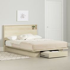 a bed with drawers underneath it in a room