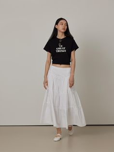 This product is a Cotton Cancan Tiered Long Skirt, meticulously designed to offer a flowing, feminine aesthetic. The skirt features multiple tiers that add volume and graceful movement with each step. Made from soft cotton, this piece ensures comfort and breathability, making it suitable for both casual and more dressed-up occasions. - The long skirt is structured with several layers, creating a full and dynamic silhouette that captures a romantic style.- Crafted from pure cotton, the fabric is both soft and lightweight, ideal for keeping cool during warmer months.- Its elastic waistband allows for a flexible fit, accommodating various body sizes comfortably.- The all-white color enhances its versatility, allowing it to be paired with a wide range of top styles and colors. Tiered Long Skirt, Long Tiered Skirt, Graceful Movement, Feminine Aesthetic, Romantic Style, All White, Body Size, A Romantic, Long Skirt