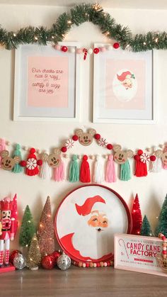 a mantle with christmas decorations and pictures on it, including santa's face in the center