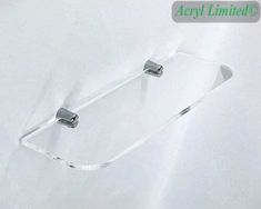 a pair of metal clips are attached to a white sheet with the word acryl limited on it