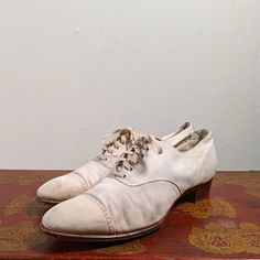 "White nubuck leather oxfords circa 1920s! Measurements Sizing on shoes is always approximate, and I urge you to take careful measurements and ask any questions prior to purchasing. I believe these are an approximate size 7 US women's (I wear a 7.5 and they're just slightly narrow at the toe), but please check the following measurements. 10\" inner sole length 3 1/8\" width measured across the bottom of the sole at the ball of the foot and 9.25\" circumference measured at the same point 1\" heel Fitted Vintage Oxfords For Derby, Vintage Pointed Toe Fitted Oxfords, Vintage Fitted Oxfords With Pointed Toe, Vintage Lace-up Oxfords With Rubber Sole, Vintage Oxfords With Rubber Sole, Vintage Fitted Oxfords With Leather Sole, Vintage Oxford Shoes With Rubber Heel Cap, Vintage Lace-up Leather Shoes With Brogue Detailing, Vintage Fitted Brogue Oxfords