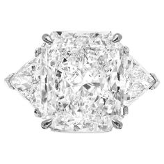 This exquisite ring features a GIA Certified 8.30 carat radiant cut diamond, elegantly set in a luxurious platinum band. The diamond boasts a G color grade, offering a near-colorless appearance that ensures a bright and captivating sparkle. With a clarity grade of SI1, the diamond contains very, very slight inclusions that are extremely difficult to detect even under 10x magnification, representing superior diamond quality. The diamond's exceptional craftsmanship is highlighted by its excellent 10 Carat Diamond Ring, Radiant Cut Diamond Ring, Trillion Diamonds, Cushion Cut Diamond Ring, Contemporary Engagement Rings, Future Engagement Rings, Modern Engagement Rings, Contemporary Ring, Radiant Cut Diamond