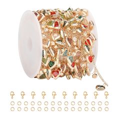 a spool of gold plated metal with lots of different colored stones on it