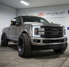 a silver truck is parked in a garage