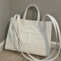 White Telfar Shopping Bag Like New Tag Still In Tact Designer Large Capacity White Shoulder Bag, Luxury White Shoulder Bag With Large Capacity, White Luxury Large Capacity Shoulder Bag, Luxury White Large Capacity Shoulder Bag, Luxury Large Capacity White Shoulder Bag, Designer White Bags With Large Capacity, Designer Large Capacity White Bags, Luxury Large Capacity White Satchel, Elegant Tan Bag With Large Capacity