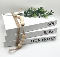 three books with beads tied to them on top of each other and the words god, bliss, our home