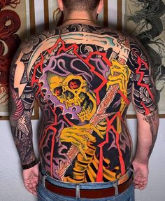 a man with tattoos on his back and arms