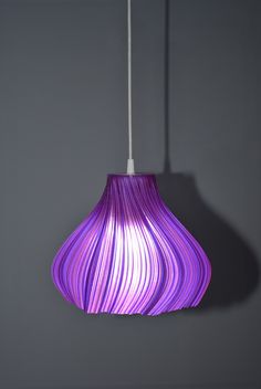 a purple light hanging from a ceiling fixture