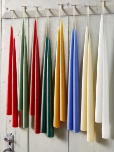 colorful umbrellas hanging from hooks on a white wall